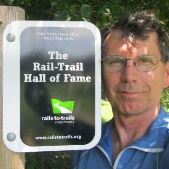 Jim-Schmid-next-to-Rail-Trail-Hall-of-Fame-sign-on-Virginia-Creeper-Trail-Damascus-VA-07-10-2016