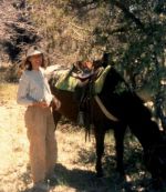 Sandra-Schmid-resting-next-to-horse-on-trail-ride-Sunflower-AZ-1991