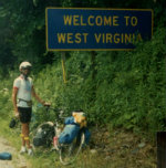 Jim-Schmid-at-WV-state-sign-AYH-Cross-Country-Bike-Trip-1987